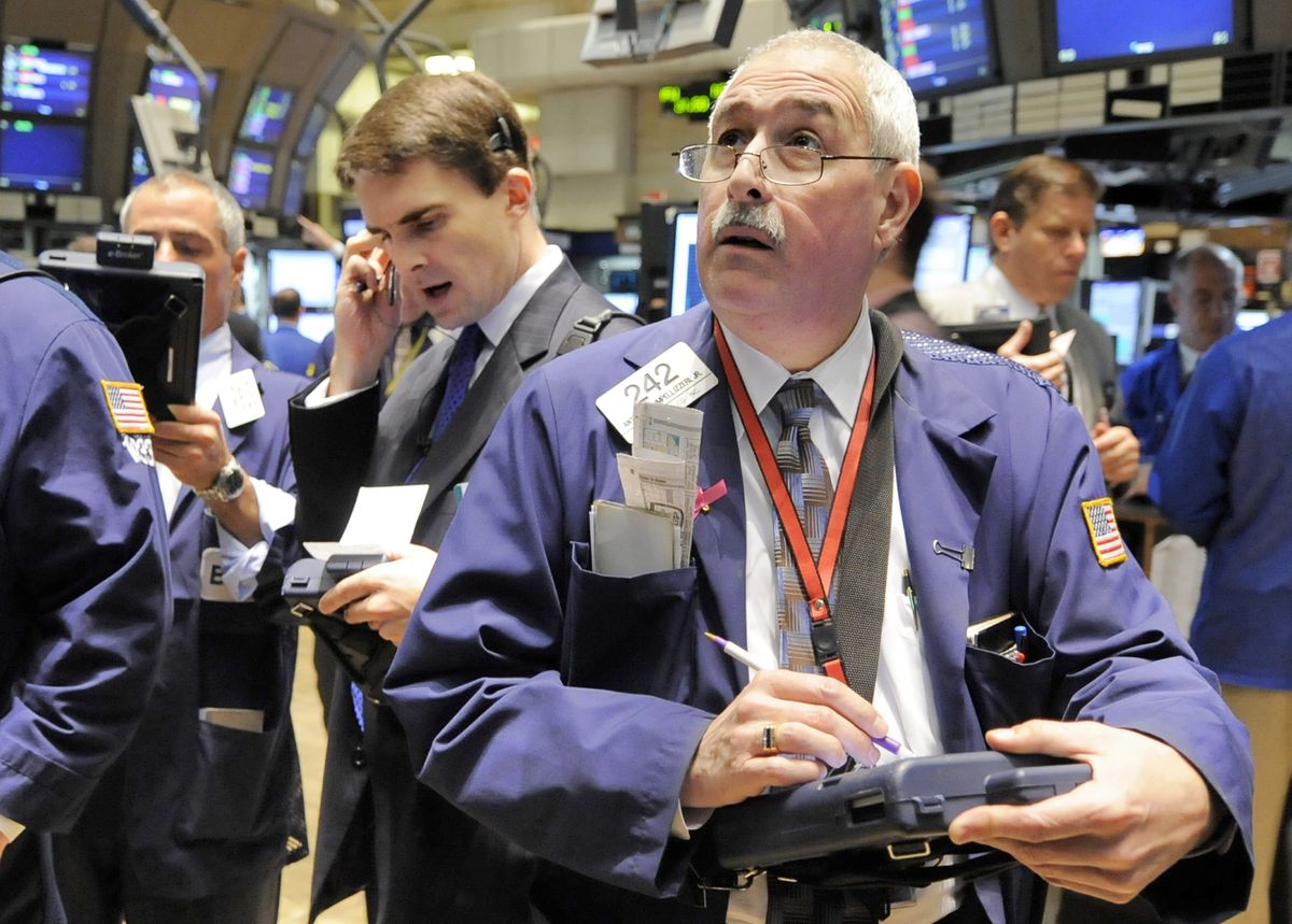 Traders work on the floor of the New York Stock Exchange on Tuesday. Wall Street fluctuated after its record-setting advance on Monday. The Dow Jones industrial average finished down Tuesday, but the 76.62-point decline was relatively modest after last week’s run of big drops. Associated Press photos (Associated Press photos / The Spokesman-Review)