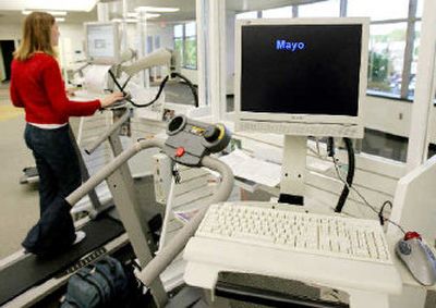 The Mayo Clinic logo flashes across a workstation in Rochester, Minn., that combines a computer, desk and treadmill into one unit, offering an alternative to being sedentary in front of the computer.
 (Associated Press / The Spokesman-Review)