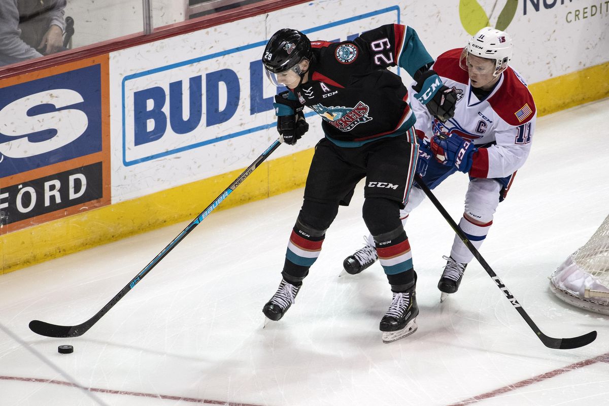 Kelowna Rockets forward Nolan Foote (29) and Spokane Chiefs forward Jaret Anderson-Dolan (11) chase the puck during the first period of a WHL hockey game, Fri., Feb. 1, 2019, at the Spokane Arena. (Colin Mulvany / The Spokesman-Review)