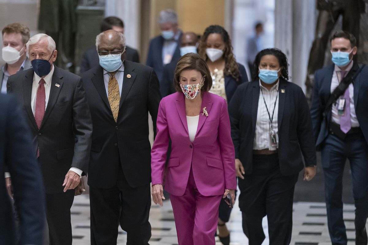 Speaker of the House Nancy Pelosi, D-Calif., center, joined from left by House Majority Leader Steny Hoyer, D-Md., and House Majority Whip James Clyburn, D-S.C., walks to update reporters after day of delays in the vote to advance President Joe Biden