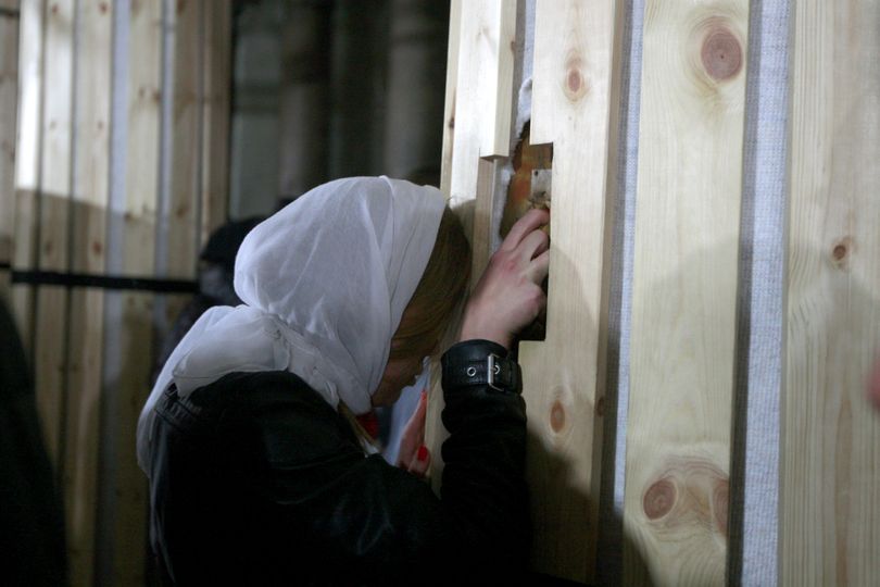 A Christian pilgrim touches a column inside the Church of the Nativity, believed by Christians to be the birthplace of Jesus Christ, in the town of Bethlehem on Tuesday. (Associated Press)