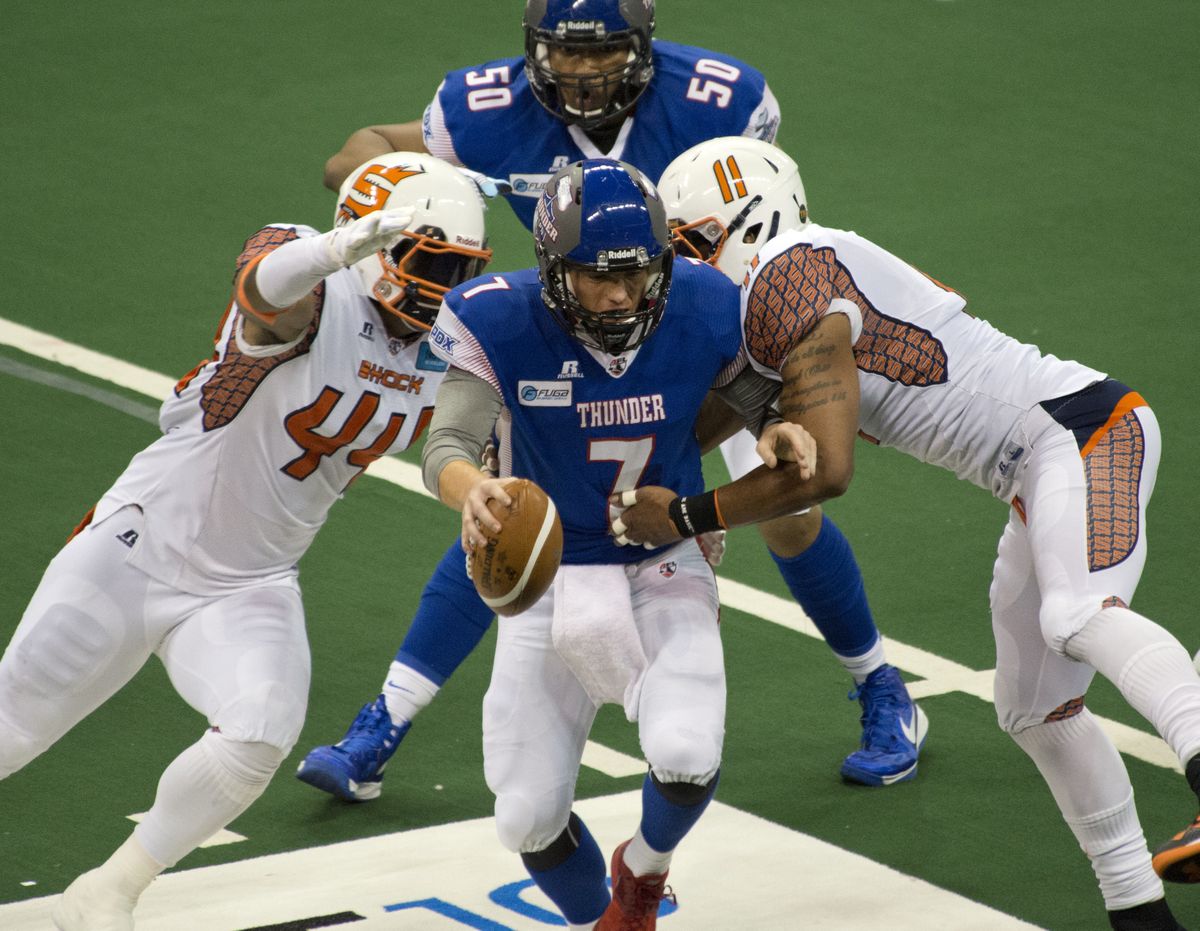 Shock linemen James Ruffin, left, and Diyral Briggs sack Thunder quarterback Danny Southwick in the first quarter of Saturday night’s game at the Arena. (Dan Pelle)