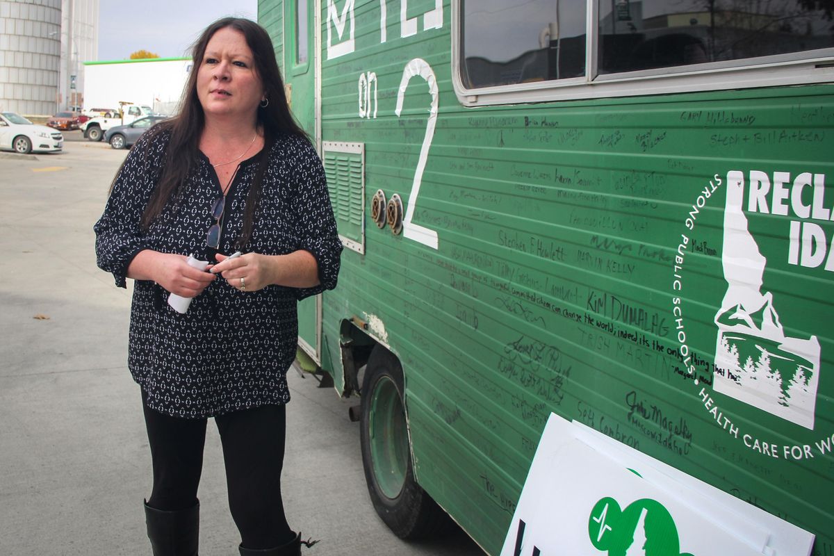Jenenne Newbre, 48, of Moscow, Idaho, was without health insurance when she was diagnosed with a brain tumor. Healthy again, she signed the Proposition 2 bus during a campaign rally Thursday for the ballot measure that would expand Medicaid in Idaho. (Becky Kramer / The Spokesman-Review)