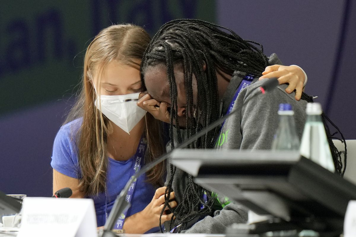 Ugandan climate activist Vanessa Nakate, right, is comforted by Swedish activist Greta Thunberg as she is overcome by emotion after speaking at the opening of a three-day Youth for Climate summit in Milan, Italy, Tuesday, Sept. 28, 2021.  (Luca Bruno)