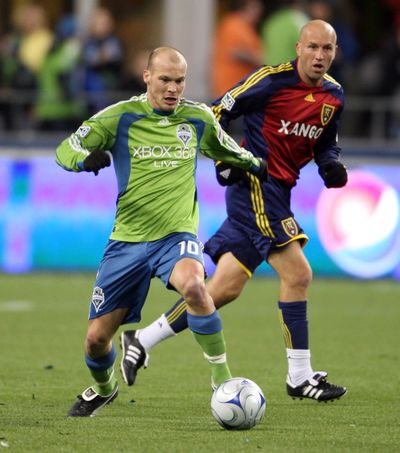 Seattle Sounders forward Freddie Ljungberg, left, will honor his two-year contract with the team instead of transferring to Europe. (Associated Press / The Spokesman-Review)