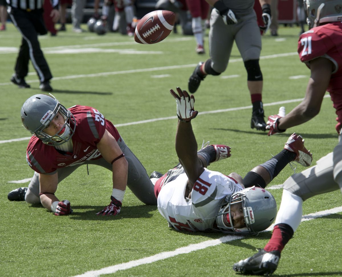 Receiver Kristoff Williams reaches for pass but Beau Glover, left, would gather in the ball for an interception. (Dan Pelle)