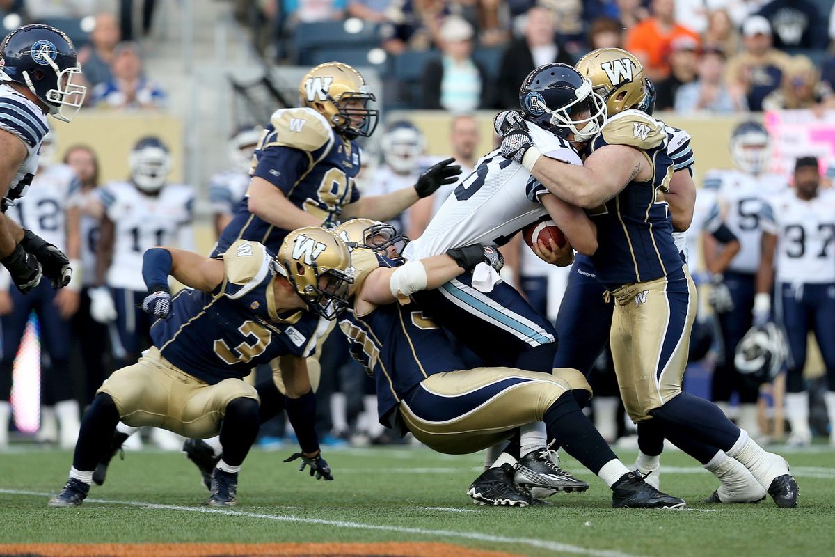 Former EWU standout Greg Peach, center, currently plays for the Winnipeg Blue Bombers and has enjoyed six years in the CFL. (Associated Press)