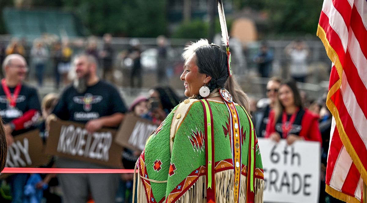 Sacajawea descendant Lacey Abrahamson holds part of the ribbon at Sacajawea Middle School during the ribbon cutting for the new building in Spokane on Tuesday, Sept. 5, 2023.  (Kathy Plonka/The Spokesman-Review)