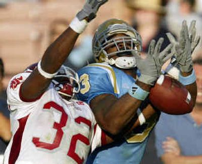 Washington State's Omowale Dada (32) is called for pass interference while defending UCLA's Tab Perry.
(Associated Press / The Spokesman-Review)
