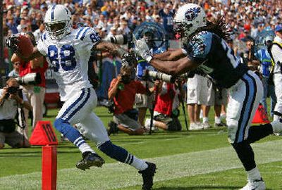 
Colts receiver Marvin Harrison, left, and the Indy offense had little trouble scoring against the Titans. 
 (Associated Press / The Spokesman-Review)