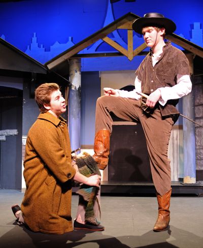 Planchet, played by Aaron Ackermann, left, cleans the boot of D’Artagnan, played by Jacob Johnson, in “The Three Musketeers,” opening Friday at Theater Arts for Children Studio. (Colin Mulvany)