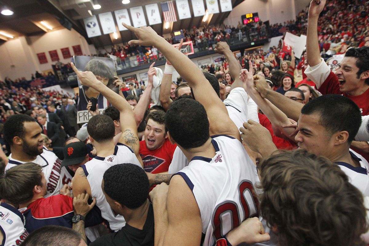Saint Mary’s students rush the court to celebrate with players after beating Gonzaga 83-62 on Jan. 12, 2012. (Tony Avelar / AP)