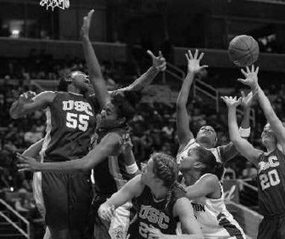 
USC's Morghan Medlock (55) and Nicole Berberet (20) fight for a rebound against UW.
 (Associated Press / The Spokesman-Review)