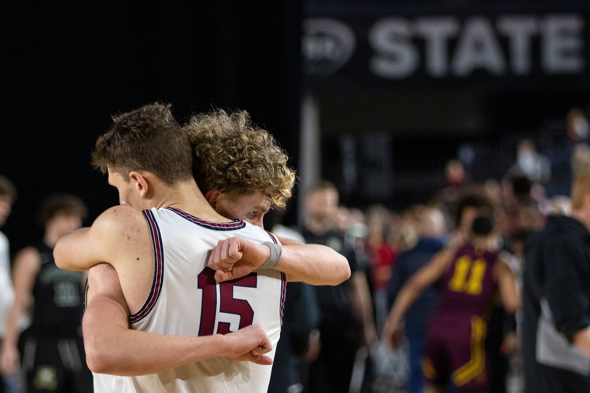 Mt. Spokane’s Maverick Sanders, front, and teammate Ryan Lafferty hug after their loss to O’Dea in the semi-finals of the 3A Boys State Basketball Tournament in Tacoma, Wash., on Friday, March 3, 2023. (Patrick Hagerty)