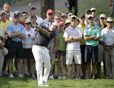 Phil Mickelson hits from off the 17th fairway to the green during the third round of the Bridgestone Invitational.  (Associated Press)