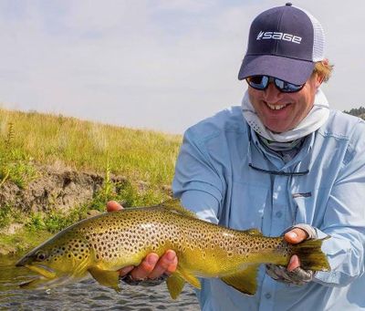 Mark Raisler of Headhunters Fly Shop in Craig, Montana, holds a brown trout caught in the Missouri River. (Courtesy Photo)