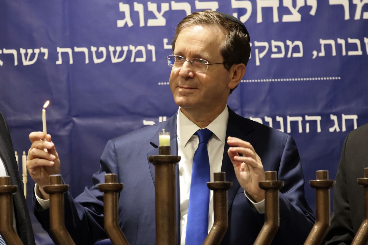 Israeli President Isaac Herzog lights candles during the Jewish holiday of Hanukkah in Hebron