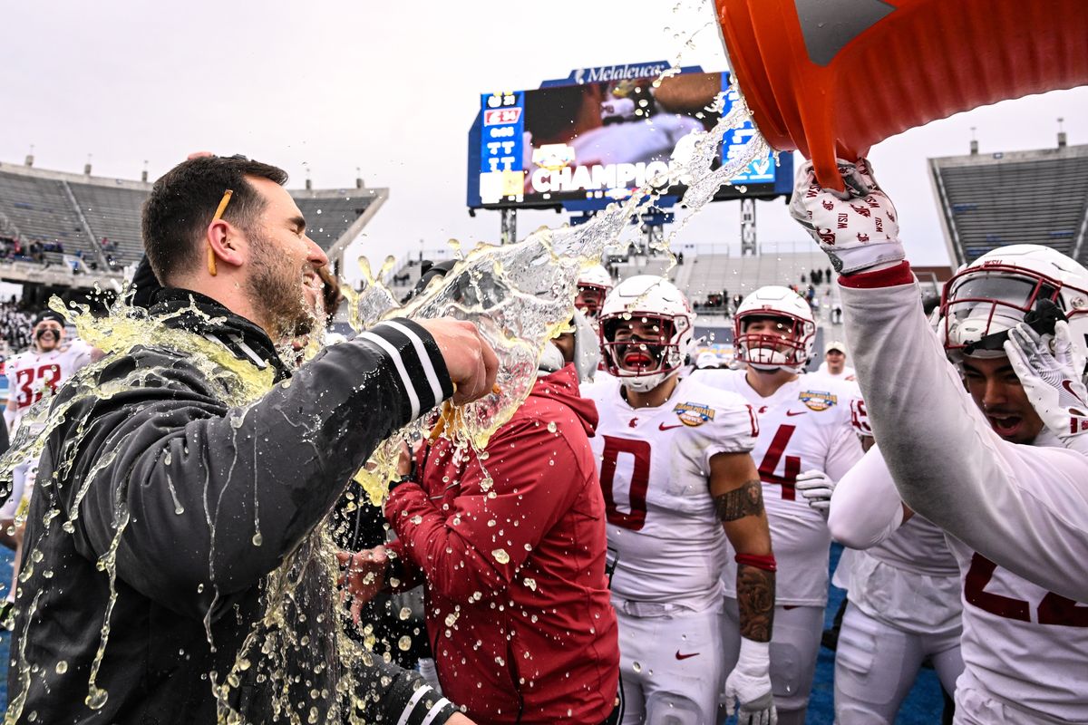 Washington State interim head coach Jesse Bobbit is doused with Gatorade and french fies after defeating the Utah State Aggies to win the Famous Idaho Potato Bowl on Monday, Dec 22, 2025, at Albertsons Stadium in Boise, Id. WSU won the game 34-21.  (Tyler Tjomsland/The Spokesman-Review)