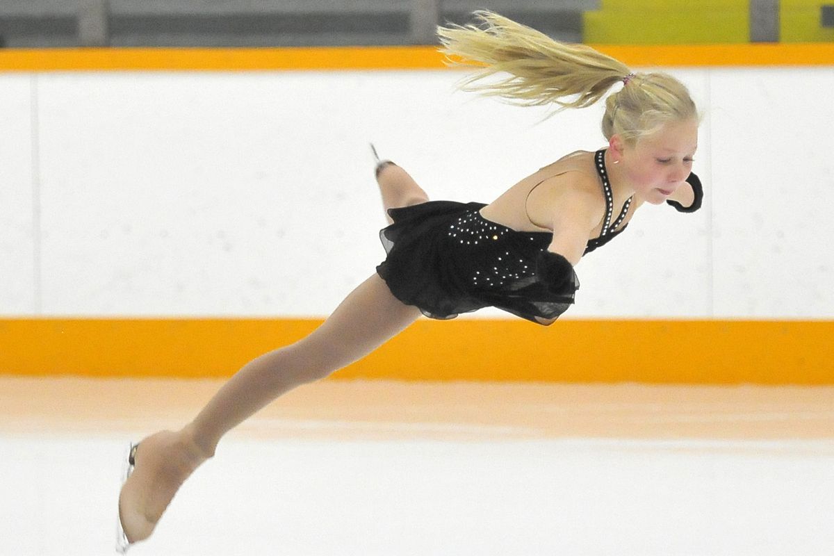 Kayleigh Elliott, 11, does a butterfly leap into a spin recently during a practice at Eagles Ice-A-Rena. Elliott has qualified for junior nationals in the juvenile division. (Jesse Tinsley)