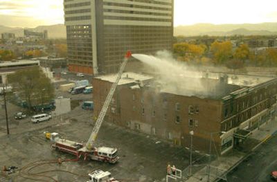 
Firemen spray water on the smoldering remains of a hotel fire Wednesday in Reno, Nev. Six people died in the blaze, and a woman was arrested Wednesday on arson and murder charges. 
 (Associated Press / The Spokesman-Review)