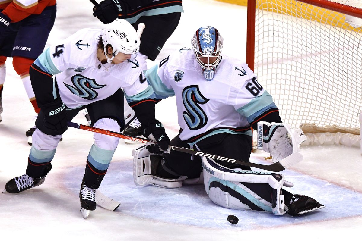 Seattle Kraken goaltender Chris Driedger (60) makes a save against the Florida Panthers next to defenseman Haydn Fleury (4) during the second period of an NHL hockey game Saturday, Nov. 27, 2021, in Sunrise, Fla.  (Jim Rassol)