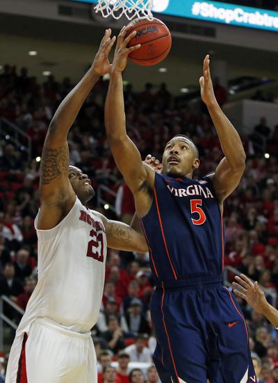 Virginia's Darion Atkins, right, drives in win over N.C. State. (Associated Press)