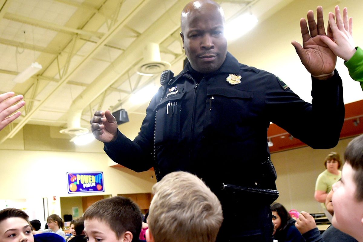 School resource officer Ed Richardson greets students at Mullan Road Elementary in Spokane on Thursday, March 9, 2017. Spokane public schools have proposed a change in policy regarding use of force. Kathy Plonka /THE SPOKESMAN-REVIEW (Kathy Plonka / The Spokesman-Review)