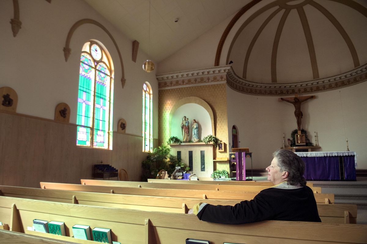 Louise Andrews sits in the sanctuary of St. Patrick Catholic Church in Hillyard Friday, Mar. 16, 2018. The church will celebrate its 125th anniversary Saturday, Mar. 17 with a mass and social. (Jesse Tinsley / The Spokesman-Review)