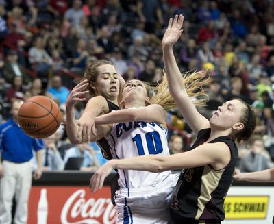 Colton’s Zoe Moser is fouled by Sunnyside Christian’s Annie Brouwer, left, during their WIAA 1B Girls Hardwood Classic championship game last March. This week, Moser and the Wildcats will attempt to win their eighth straight B title. (Dan Pelle / The Spokesman-Review)