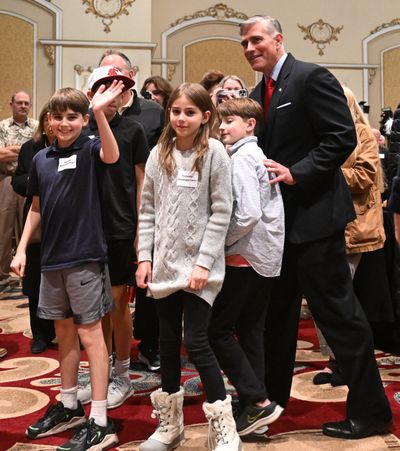 After early results show him ahead, representative-elect Michael Baumgartner walks with his family through the crowd Tuesday in the ballroom of the Historic Davenport Hotel.  (Jesse Tinsley/THE SPOKESMAN-REVIEW)