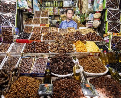 A man hawks dates and other dried fruits in one of the thousands of stalls in the souks of the ancient walled city in Fez. (Bob Drogin / TNS)