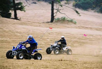 
 ATV riders race in the Oregon Dunes National Recreation Area near North Bend, Ore., in 2003.
 (File/Associated Press / The Spokesman-Review)