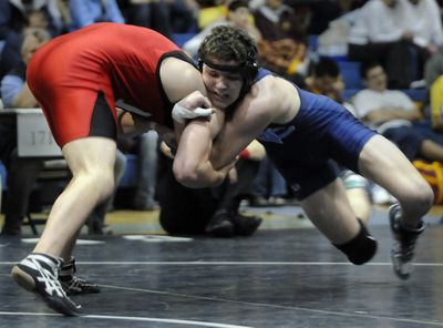 Ferris’ Ian Bauman, left, drives forward against ultimate winner Cody Stratton of Central Valley in the 171-pound final.  (Jesse Tinsley / The Spokesman-Review)