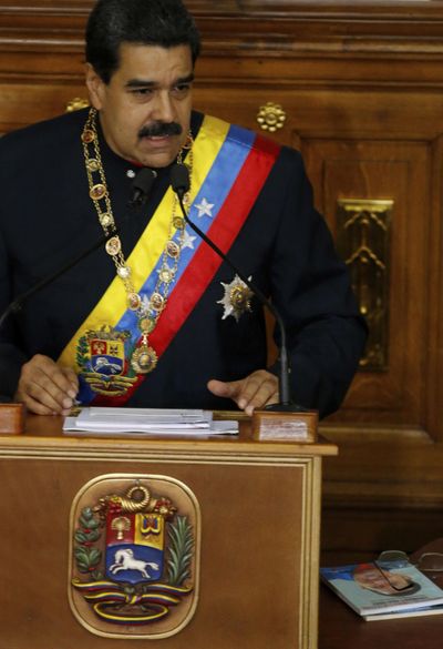 Venezuela’s President Nicolas Maduro addresses Constitutional Assembly members at the National Assembly building in Caracas, Venezuela, Thursday, Aug. 10, 2017, as a book at his right shows the face of his late predecessor Hugo Chavez, which outlines Chavez’s project, coined “Plan de Patria,” or “Plan Homeland.” (Ariana Cubillos / Associated Press)