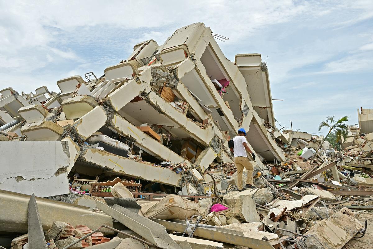 A relatives of missing people searches for bodies amid the rubble of a collapsed building in Caraballeda, La Guaira State, Venezuela on July 13, 2026, following the June 24 twin earthquakes.  (Martin Bernetti/AFP/Getty Images North America/TNS)