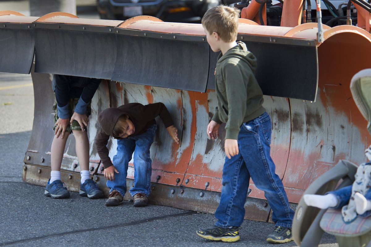 Children gets hands-on experience with a city of Spokane snowplow during the fourth annual Touch a Truck event on Saturday at Spokane Community College. The Junior League of Spokane-sponsored gathering included several city work vehicles. (PHOTOS BY DAN PELLE)