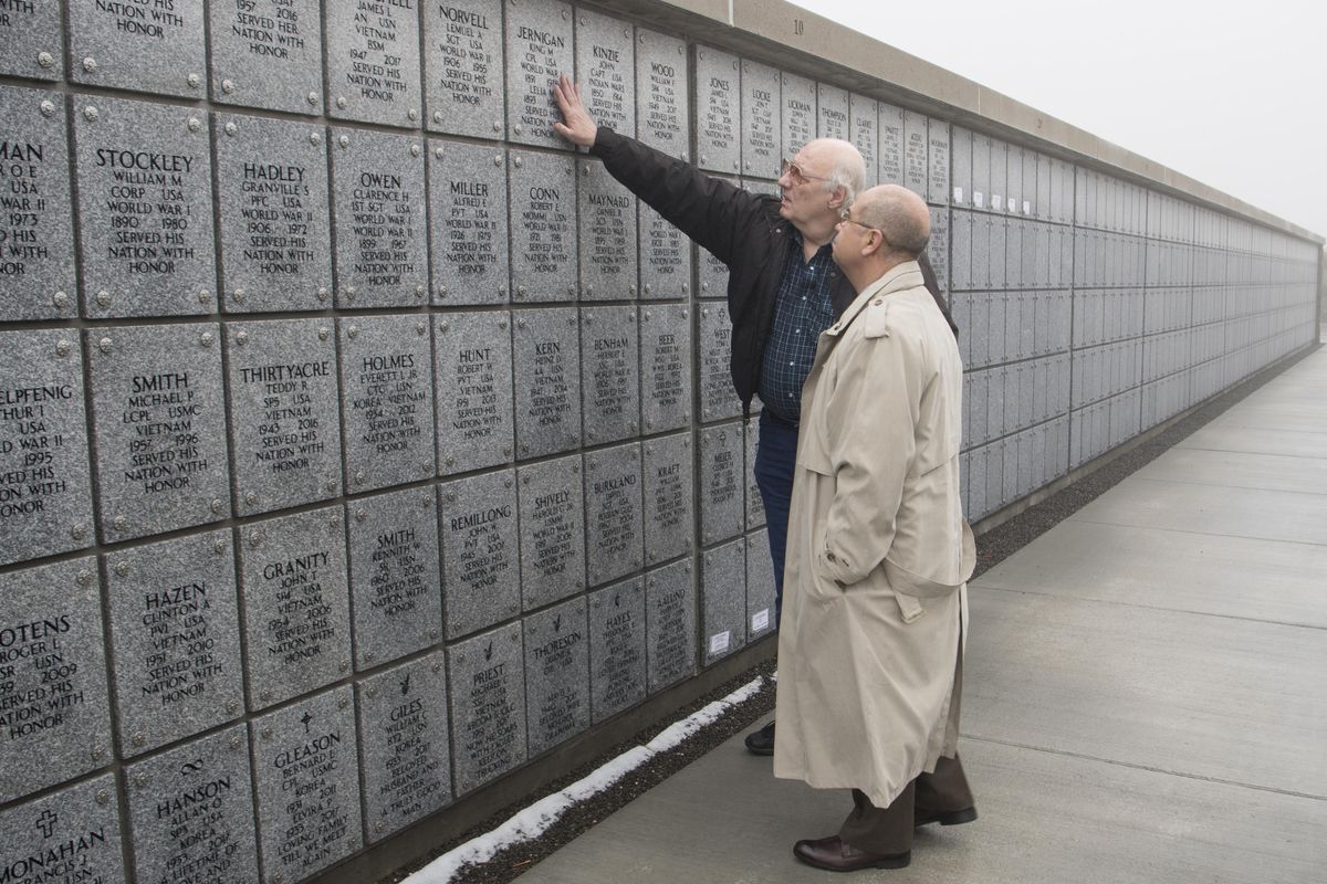 Rick Valentine, left, talks with cemetery director Rudy Lopez about some of the veterans he and other “grave finders” have located and referred for burial at the Washington State Veterans Cemetery in Medical Lake on Friday, Feb. 2, 2018. Grave finders hunt down clues to unclaimed ashes at local cemeteries and funeral homes. Their work has brought many unclaimed remains of veterans to the veterans cemetery. (Jesse Tinsley / The Spokesman-Review)