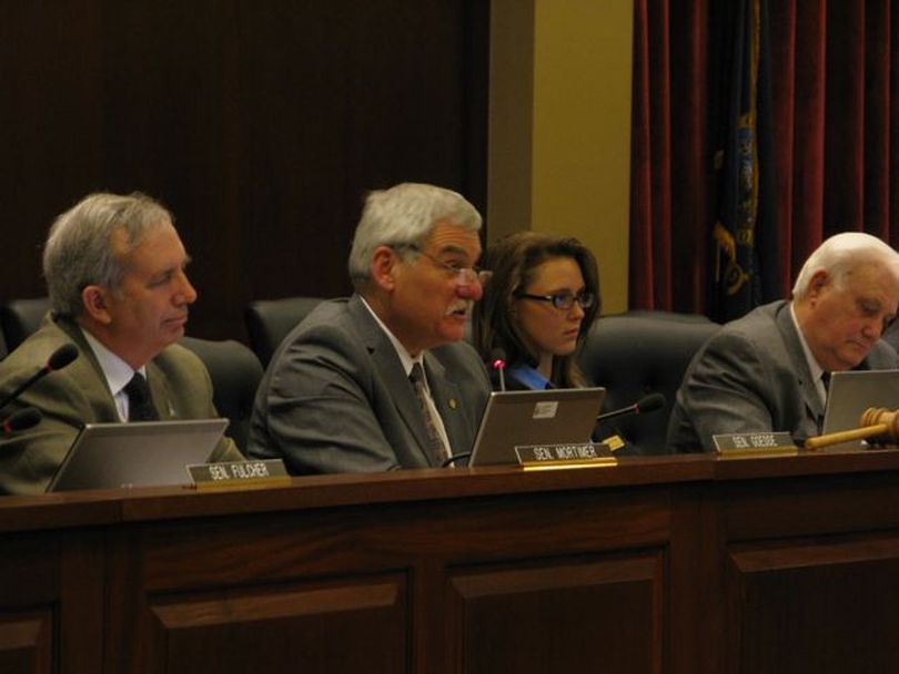 Sen. John Goedde, R-Coeur d'Alene, listens to testimony Thursday evening from opponents of the Luna school reform plan; at left is Sen. Dean Mortimer, R-Idaho Falls; second from right is committee secretary Sara Pealy; and at right is Sen. John Andreason, R-Boise.
 (Betsy Russell)