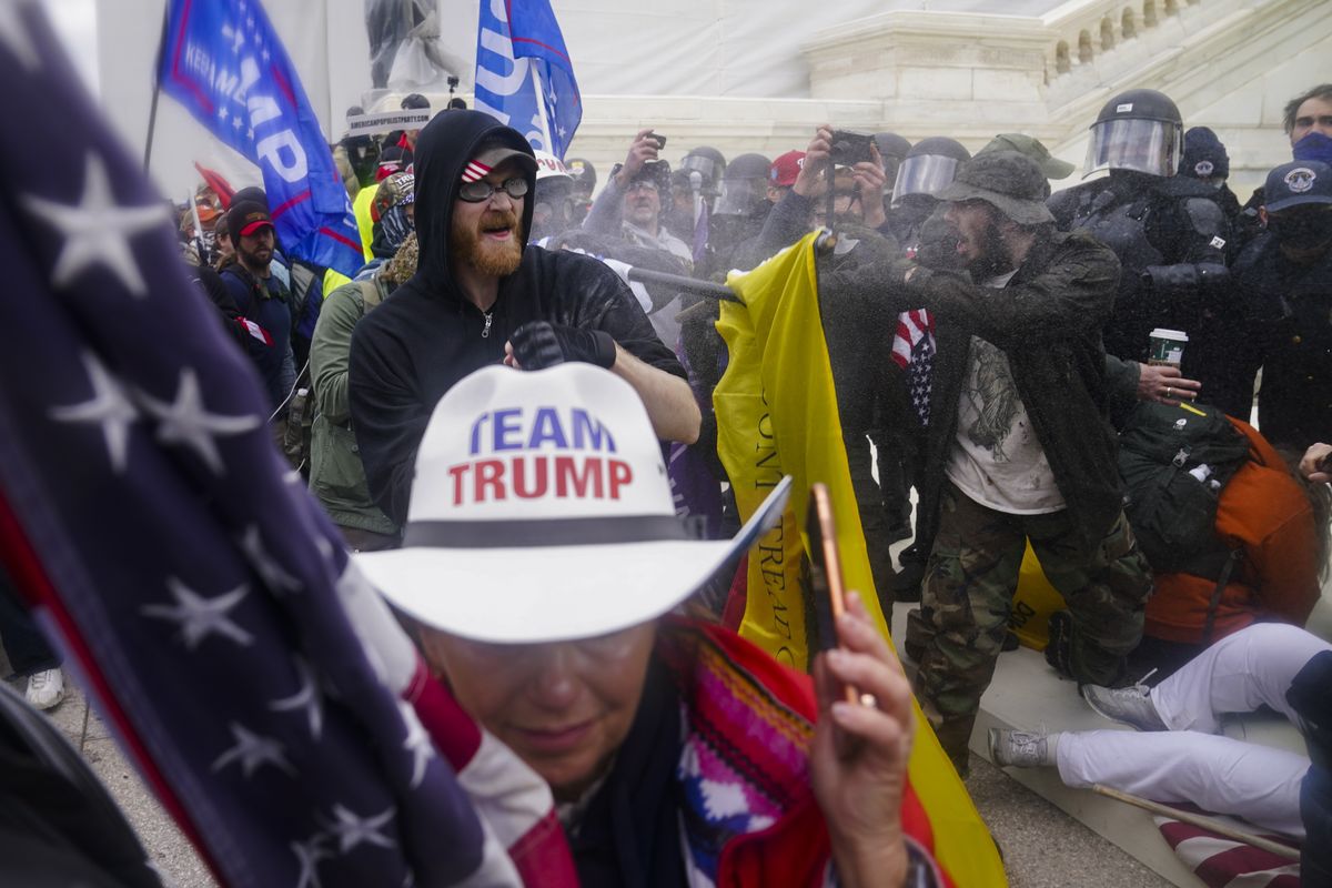 FILE - In this Jan. 6, 2021, file photo, rioters try to break through a police barrier, at the Capitol in Washington.  (John Minchillo)