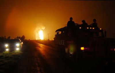 
Smoke and flames from an explosion at a gas pipeline near Queretaro, Mexico, are seen Tuesday as a Mexican army truck drives by.Associated Press
 (Associated Press / The Spokesman-Review)