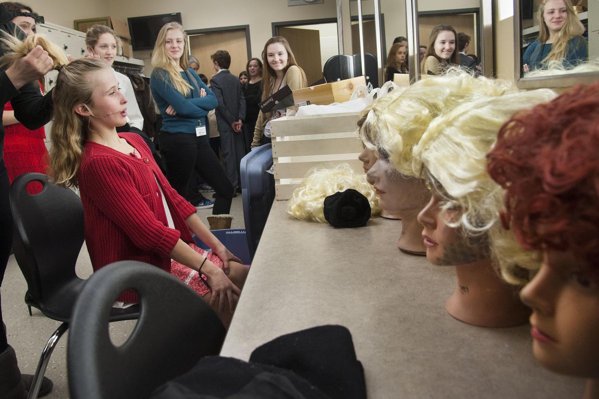 Corinne Webster, Cataldo Catholic School sixth-grader, is prepped in the Ferris High School auditorium green room for a red wig for her lead role as "Annie Jr." Cataldo