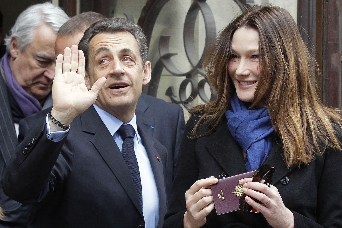 French President and UMP candidate Nicolas Sarkozy and his wife, Carla Bruni-Sarkozy, leave after casting their votes in the first round of French presidential elections in Paris on Sunday. (Associated Press)