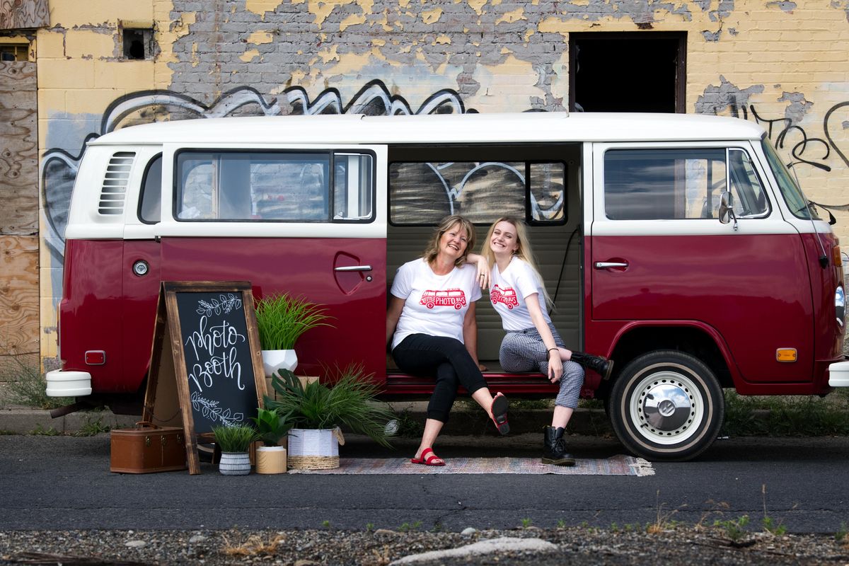 Deanna Haggerty and her daughter Kyra pose for a photo with their 1976 Volkswagen bus they operate out of as The Little Photo Bus Company. Shown here on Friday, June 22, 2018, in Spokane. (Tyler Tjomsland / The Spokesman-Review)