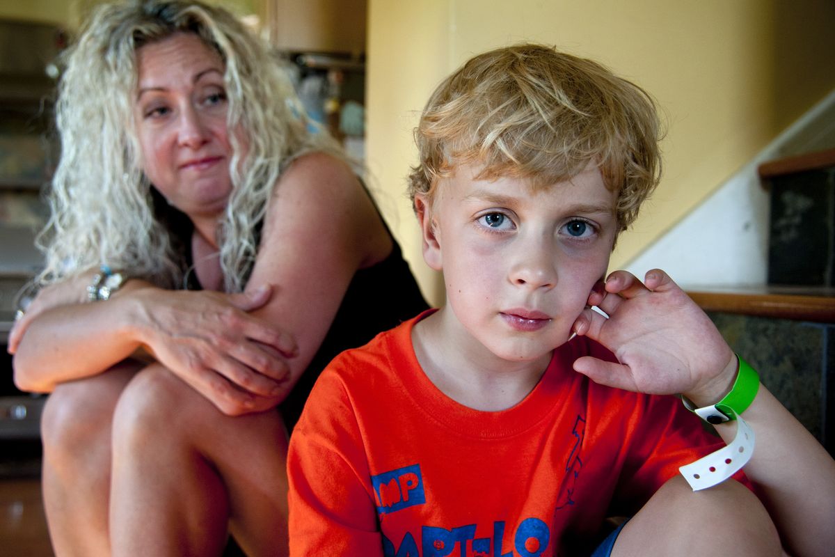Mike Mitchell, 5, was playing with a Halloween toy eyeball when it leaked what is thought to be kerosene into his right eye on July 13 in Spokane. His mother, Heidi, left, flushed the eye with water and rushed him to the emergency room for treatment. (Dan Pelle)