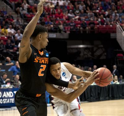 Gonzaga's Angel Nunez is hacked by against Oklahoma State's Le'Bryan Nash in the second half, March 21, 2014 at the NCAA Division I Men's Basketball Championship second round game in San Diego.  (Dan Pelle)