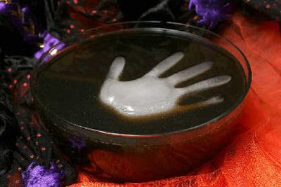 
A floating hand made by freezing water in a glove is the centerpiece of this Black Halloween Punch. 
 (The Spokesman-Review)