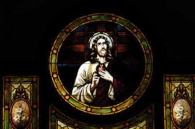 The face of Christ looks down from a restored stained-glass window in front of St. Michael's Catholic Church in Worley on Friday. The glass once had two bullet holes in it. A renovation project expanded the tiny church.
(Jesse Tinsley photos/ / The Spokesman-Review)