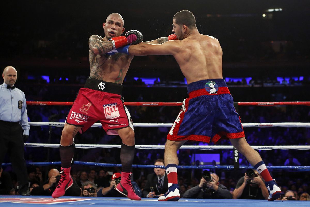 Miguel Cotto, left, of Puerto Rico, and Sadam Ali trade blows during the second round of a WBO junior middleweight title boxing match Saturday, Dec. 2, 2017, in New York. (Adam Hunger / Associated Press)