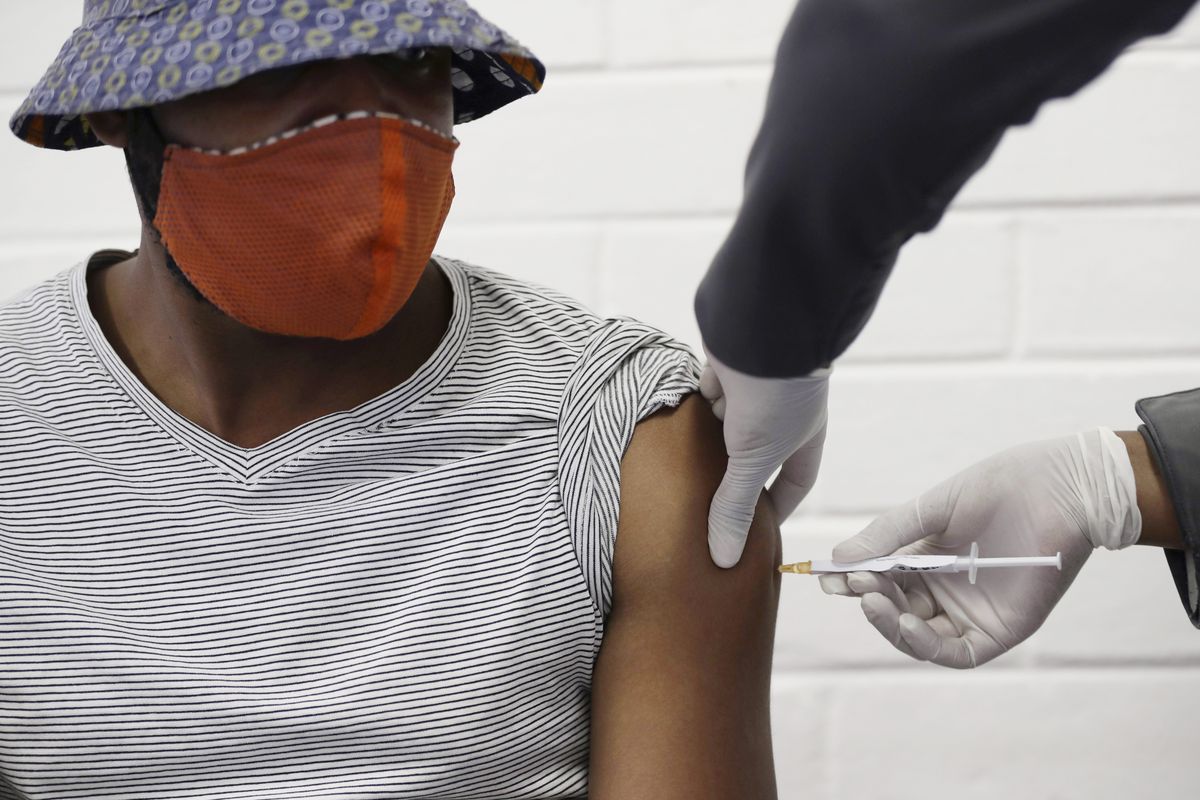 FILE - In this Wednesday, June 24, 2020 file photo, a volunteer receives a COVID-19 test vaccine injection developed at the University of Oxford in Britain, at the Chris Hani Baragwanath hospital in Soweto, Johannesburg, South Africa. Politicians and public health leaders have publicly committed to equitably sharing any coronavirus vaccine that works, but the top global initiative to make it happen may allow rich countries to reinforce their own stockpiles while making fewer doses available for poor ones. (Siphiwe Sibeko)