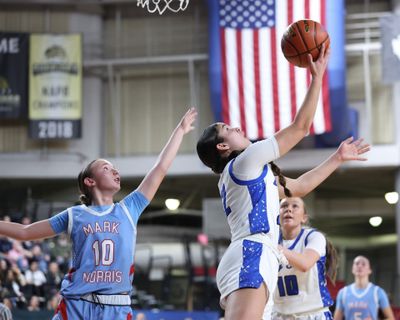 Deer Park player Ashlan Bryant puts up a shot against Mark Morris during the State 2A girls basketball tournament at the Yakima Valley SunDome.  (S.Carter Action Images)